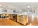 Well-lit kitchen with stainless appliances, wood cabinets, and an island overlooking the living area at 14582 E Harvard Ave, Aurora, CO 80014