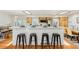 Bright kitchen featuring a breakfast bar with seating, wood cabinets, and stainless steel appliances at 14582 E Harvard Ave, Aurora, CO 80014