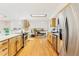 Open concept kitchen with stainless steel appliances, wood cabinets, and hardwood floors at 14582 E Harvard Ave, Aurora, CO 80014