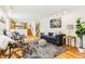 Spacious living room featuring hardwood floors, comfortable seating, and an open floor plan at 14582 E Harvard Ave, Aurora, CO 80014