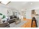 Bright living room featuring hardwood floors, a comfortable sofa, and stylish decor at 14582 E Harvard Ave, Aurora, CO 80014