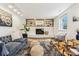 Bright living room showcasing hardwood floors, a cozy fireplace, and stylish furnishings at 14582 E Harvard Ave, Aurora, CO 80014