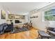 Comfortable living room with hardwood floors, modern furniture, and a fireplace at 14582 E Harvard Ave, Aurora, CO 80014