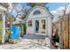 Charming outbuilding with blue trim and gray deck, perfect for backyard office or hobby space at 14582 E Harvard Ave, Aurora, CO 80014