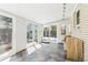 Bright sunroom with tile flooring, exposed brick, and sliding glass doors leading to the outdoors at 14582 E Harvard Ave, Aurora, CO 80014