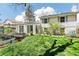 Bright sunroom and backyard featuring a lush lawn and garden with raised beds at 14582 E Harvard Ave, Aurora, CO 80014