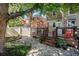 Charming backyard with stone patio, wooden deck, and a lush garden under the shade of mature trees at 1419 N Adams St, Denver, CO 80206