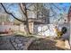 Well-maintained backyard with stone pathway, wooden shed, and a charming outdoor dining space at 1419 N Adams St, Denver, CO 80206