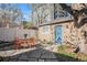 Charming backyard space with stone patio, wooden shed with a blue door, and a small seating area at 1419 N Adams St, Denver, CO 80206
