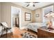 Cozy bedroom featuring wood floors, neutral walls, and a ceiling fan for added comfort at 1419 N Adams St, Denver, CO 80206
