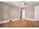 Neutral bedroom with hardwood floors, ceiling fan, and white trim and doors at 1419 N Adams St, Denver, CO 80206