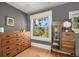 Bedroom with hardwood floors, a large window, and classic wood furniture, including a dresser and display cabinet at 1419 N Adams St, Denver, CO 80206
