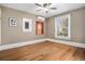 Neutral bedroom with hardwood floors, two windows and ceiling fan at 1419 N Adams St, Denver, CO 80206