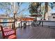 Spacious outdoor deck area perfect for entertaining with dark wood flooring, black railings, seating, and umbrella-covered table at 1419 N Adams St, Denver, CO 80206