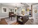 Bright dining room open to kitchen with hardwood floors, and island with seating at 1419 N Adams St, Denver, CO 80206