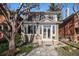 Inviting two-story home with an attractive front yard, stone walkway, and lush landscaping at 1419 N Adams St, Denver, CO 80206