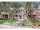 Charming two-story home with a beautifully landscaped front yard and mature trees at 1419 N Adams St, Denver, CO 80206