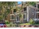 Charming two-story home with a welcoming front porch and beautifully landscaped front yard with mature trees at 1419 N Adams St, Denver, CO 80206