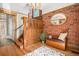 Inviting foyer with exposed brick, wooden staircase, and stylish decor at 1419 N Adams St, Denver, CO 80206