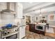 Open concept kitchen flows into dining area, featuring stainless appliances and a central island for entertaining at 1419 N Adams St, Denver, CO 80206