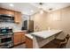 A full-size kitchen with modern appliances, stylish backsplash, quartz countertops, and bar seating at 1419 N Adams St, Denver, CO 80206