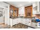 Updated kitchen with white cabinets, brick accent wall, and stainless steel appliances at 1419 N Adams St, Denver, CO 80206