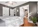 Bedroom featuring hardwood floors, white trim, ceiling fan, and multiple doors at 1419 N Adams St, Denver, CO 80206