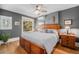 Cozy main bedroom with hardwood floors, a ceiling fan, and a large window for ample natural light at 1419 N Adams St, Denver, CO 80206