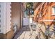 A cozy side yard features stone pavers and outdoor seating between two brick buildings at 1419 N Adams St, Denver, CO 80206