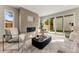 Cozy living room featuring a sleek fireplace, comfortable seating, and sliding doors that open to the backyard at 4572 N Raleigh St, Denver, CO 80212