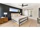Serene primary bedroom with wood paneling, a comfortable bed, and an en-suite bathroom with a sliding barn door at 4572 N Raleigh St, Denver, CO 80212