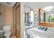 Charming bathroom with tiled shower, classic fixtures, vanity area with a double sink, and lighting at 3100 E Cherry Creek South Dr # 1507, Denver, CO 80209