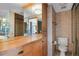 Bathroom featuring tiled walls, a vanity with storage, and a well-lit mirror in neutral tones at 3100 E Cherry Creek South Dr # 1507, Denver, CO 80209