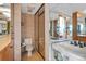 Well-lit bathroom boasts a glass-enclosed shower, tiled walls, and a mirrored vanity area at 3100 E Cherry Creek South Dr # 1507, Denver, CO 80209