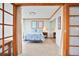 Bedroom with a king bed and two pieces of wall art viewed through french doors at 3100 E Cherry Creek South Dr # 1507, Denver, CO 80209