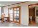 Hallway showcasing access to a bedroom through French doors and a bathroom, with tiled flooring throughout at 3100 E Cherry Creek South Dr # 1507, Denver, CO 80209