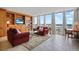 Bright living room featuring floor-to-ceiling windows and custom built-in shelving at 3100 E Cherry Creek South Dr # 1507, Denver, CO 80209