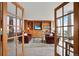 View of a cozy living area through French doors, with built-in shelving and comfortable seating at 3100 E Cherry Creek South Dr # 1507, Denver, CO 80209