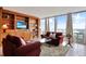Inviting living room boasts custom built-ins, large windows with city views, and comfortable seating at 3100 E Cherry Creek South Dr # 1507, Denver, CO 80209