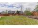 Green backyard with a wooden fence and trees at 24621 E Berry Pl, Aurora, CO 80016