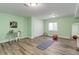 Spacious basement area with wood floors, ample natural light, closet, desk, and fitness area at 24621 E Berry Pl, Aurora, CO 80016