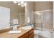 A well-lit bathroom featuring a vanity, shower and tub combo, and neutral toned walls at 24621 E Berry Pl, Aurora, CO 80016