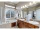 Bright bathroom featuring double sinks, granite countertops, a large window, and separate tub at 24621 E Berry Pl, Aurora, CO 80016