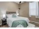 Well-lit bedroom features a cozy bed, a decorative shelf, and a window with curtains at 24621 E Berry Pl, Aurora, CO 80016