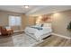 Bright bedroom featuring a comfortable chair, wood-look flooring, and large window at 24621 E Berry Pl, Aurora, CO 80016