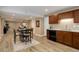 Open dining area featuring modern counters, dining table, and wood-look flooring at 24621 E Berry Pl, Aurora, CO 80016
