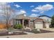 Charming brick home with a three-car garage, arched entryway, and tastefully landscaped front yard at 24621 E Berry Pl, Aurora, CO 80016