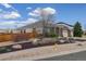 Brick home with three-car garage, arched entryway, landscaped yard, and a wooden privacy fence at 24621 E Berry Pl, Aurora, CO 80016