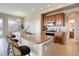 Well-lit kitchen with island, granite countertops, wood cabinets and modern stainless-steel appliances at 24621 E Berry Pl, Aurora, CO 80016