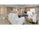 Bright living area with wood-look floors, recessed lighting, and comfortable seating arrangement at 24621 E Berry Pl, Aurora, CO 80016